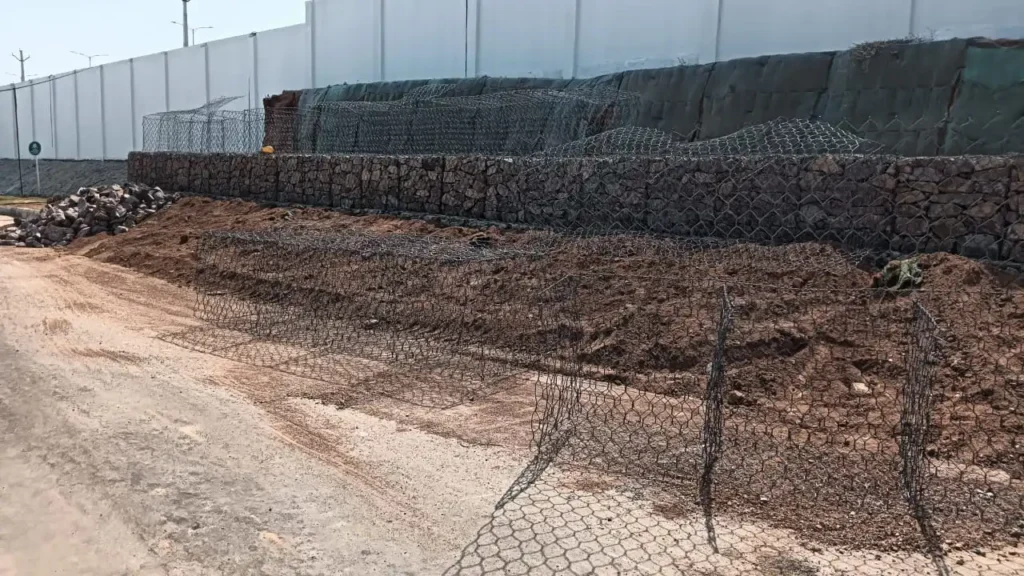 Savinaya Infratech workers  installing gabion walls for soil stabilisation