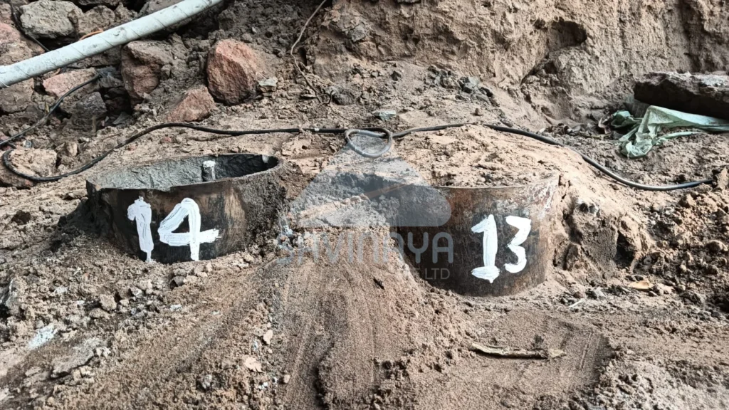 Numbered micropile casings 13 and 14 installed in soil